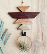 Geometric salvaged wood forms with visible grain and waxed cotton hanging cord.