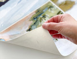 Hand holding corner, revealing textured canvas backing of the Laurie Ann art print.