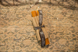 Terra cotta beeswax taper candles by Greentree Home, bundled with a branded ribbon.