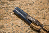 Greentree Home branded ribbon wrapped around a pair of blue slate beeswax tapers.