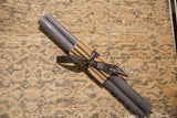 Gray 12-inch beeswax taper candles, bundled in brown paper with a branded black ribbon.