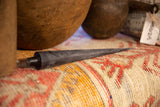 Black beeswax cone taper candle with pointed tip and subtle textured finish.