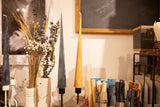 Tall and slender cone taper candle made from natural yellow beeswax.