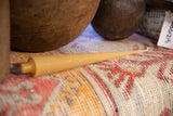 A single beeswax cone taper candle in natural color, highlighting its slender profile.