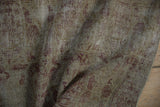 Worn antique ivory pile and visible foundation on a distressed Kerman rug.