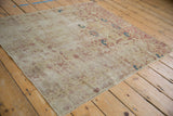 Faded cochineal red floral cross-sections and visible foundation on antique Kerman rug.
