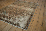 Distressed corner of vintage Hamadan rug, showing foundation and chocolate brown Samovar border.