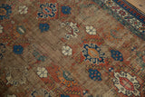 Close-up of worn lattice geometric palmettes on vintage Caucasian rug, exposed foundation.