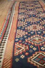 Close-up: Moghan guls with geometric diamonds, hook motifs, navy, red, blush, sky blue.