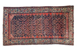 Vintage Malayer carpet with an allover Herati motif in navy blue, fuchsia, and ivory with visible wear.