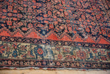 Worn knot heads and exposed foundation on this vintage Malayer carpet's field and floral border.