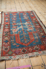 Vintage Caucasian rug displaying germinating tree of life motif, indigo field, foundation showing.