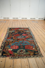 Hand knotted antique Bijar fragment with Karabagh design, cherry red roses and tattered blue edge.