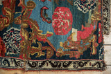 Antique Bijar rug's Karabagh design: floral motifs in cherry red, teal, brown, and a tattered edge.