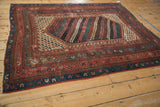 Vintage Kurdish rug corner, geometric borders, and diagonal boteh field in ruby and teal.
