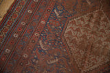 Antique Qashqai carpet with areas of visible foundation, highlighting its madder red and indigo blue.