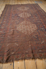 Antique Qashqai carpet close-up, revealing low pile texture, madder red, indigo blue field motifs.