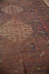 Antique Qashqai carpet showing texture of wear to knot heads and visible foundation.