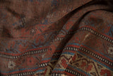 Detail of antique Qashqai carpet, tribal geometric patterns with aged madder red, indigo blue.