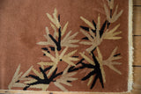 Eucalyptus leaf pattern and intact selvage on a rust Nichols Art Deco rug corner.