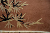 Vintage Nichols Art Deco rug corner: rust field, ivory and black eucalyptus leaves, secure fringe.