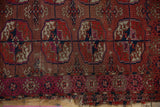 Turkmen rug geometric end borders in madder red, fuchsia, navy; tattered edge.