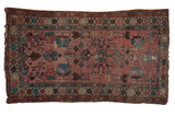 Vintage Lilihan rug, dusty rose field, off-center geometric floral motifs, crab borders, mostly even wear.