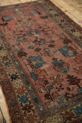 Textured detail of vintage Lilihan rug with colorful crab geometric border and dusty rose field.
