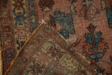 Detail of vintage Lilihan rug showing dusty rose pile, woven foundation, and threadbare wear.