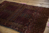Intricate vinery and geometric motifs on a vintage Turkmen rug, in wine red and navy.
