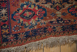 Close-up of antique Caucasian Soumac flatweave rug showing original fringe and wave border.