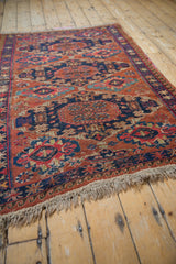 Antique Caucasian Soumac rug displaying geometric medallions and pawn design in rich, vibrant hues.