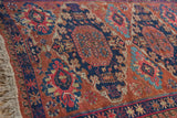 Detail of antique Caucasian Soumac rug fringe, wave, and starburst borders in chestnut, navy, fuchsia.