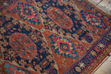 Antique Caucasian Soumac rug with geometric pawn motifs in chestnut, navy, and fuchsia.