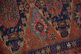 Hand woven Soumac rug with geometric pawn motifs in navy, fuchsia, and chestnut.