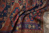 Antique Soumac rug detail: rust, navy, fuchsia geometric starburst and wave border, natural fringe.