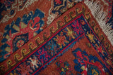Antique Caucasian Soumac rug: chestnut, navy geometric borders, vibrant pawn and wave motifs.