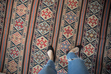 Antique Caucasian Kilim flatweave runner with geometric motifs in navy, terracotta, and ivory.