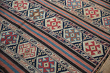 Antique Caucasian Kuba flatweave: navy, red, and ivory geometric serpent and floral motifs.