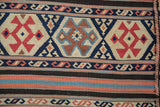 Antique Caucasian Kilim flatweave detail: black, terracotta, blue horizontal stripes and serpent motifs.