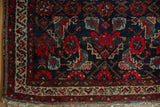 Vintage Hamadan rug corner detail, highlighting Herati design and banded borders in navy, red, ivory.