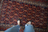 Vintage hand-knotted Hamadan rug shows navy field, red boteh, and lattice motifs.