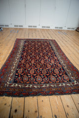 Hand-knotted vintage Hamadan rug's mostly secure fringe and geometric border.