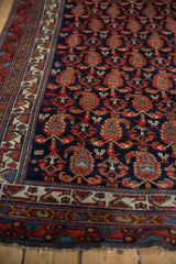 Restored corner of a vintage Hamadan rug, featuring a navy boteh field and geometric borders.