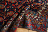 Corner view of vintage Hamadan rug with traditional geometric border and restored selvage.