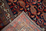 Vintage Hamadan rug corner, showing hand-knotted back and intricate navy, red, ivory boteh pattern.