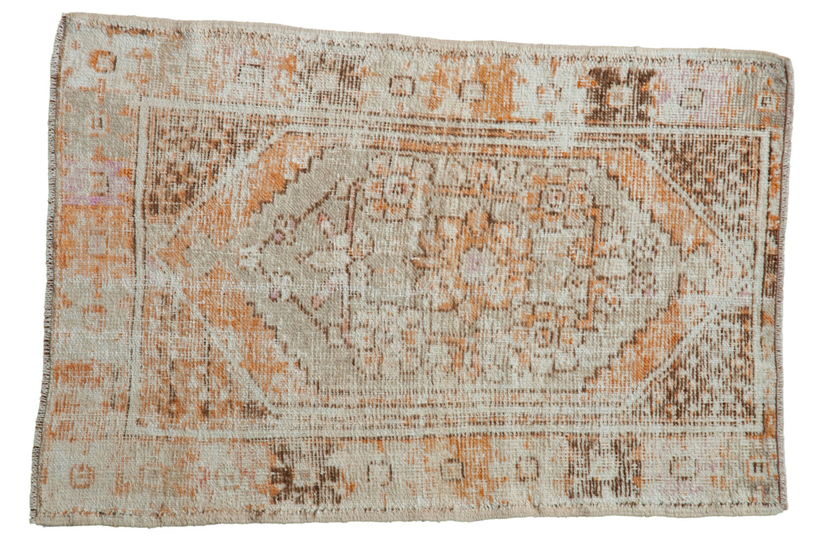 Distressed vintage Oushak rug featuring a stepped medallion in tangerine orange, brown, and worn ivory.