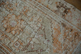 Mostly even wear on a distressed Oushak rug showing the knot heads and underlying foundation.
