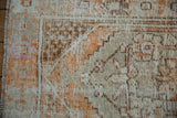 Close-up on the distressed corner of a Turkish Oushak, showing wear to the foundation weave.