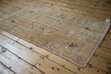 Distressed pile of vintage Oushak rug, showing foundation, sandalwood, and faded raspberry motifs.